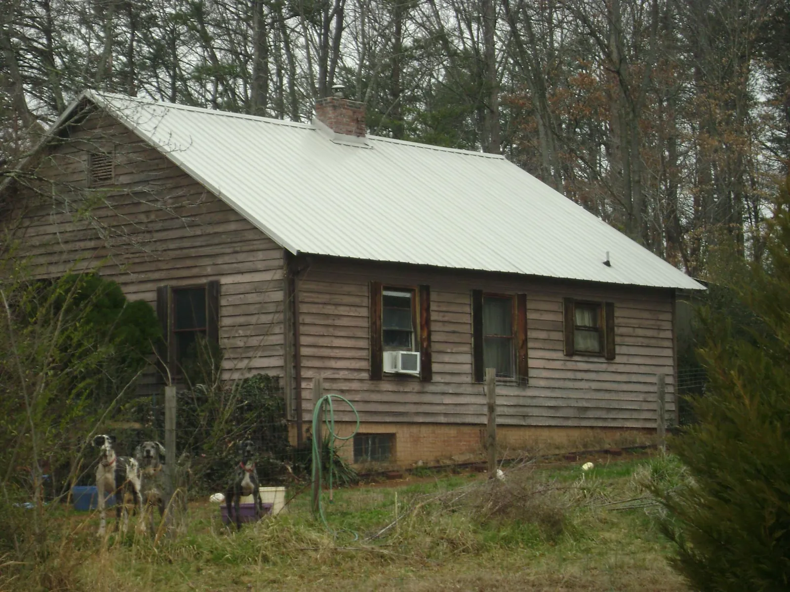 White metal roof on an old wood sided farmhouse, from a Metal Roof Installation job in Bryans Road